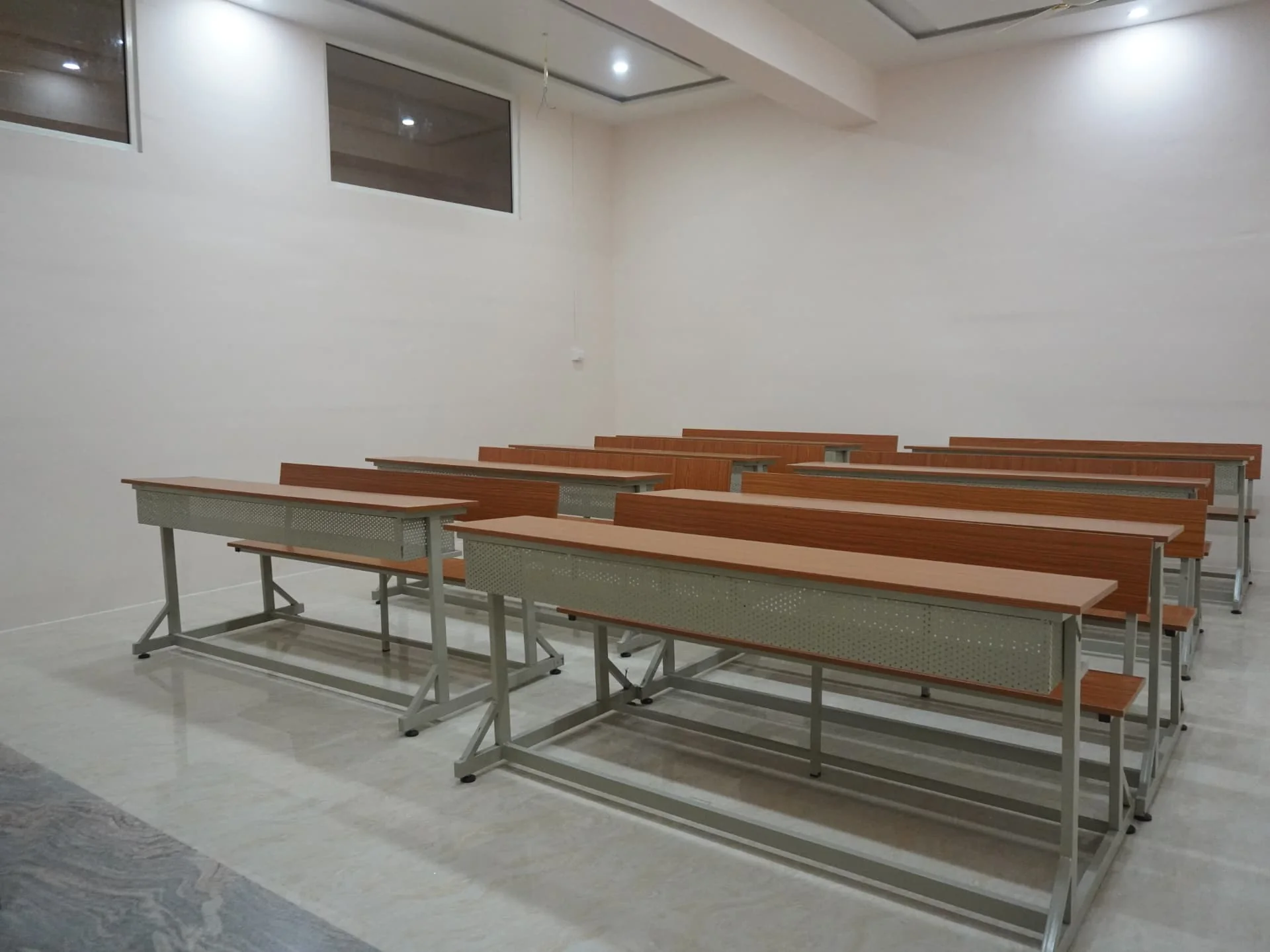 Interior of Lecture Hall 4 with tiered student desks and classroom lighting